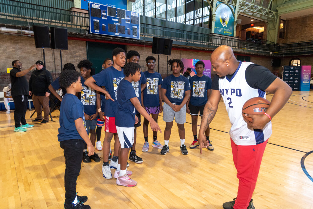 Coach provides instruction to basketball players