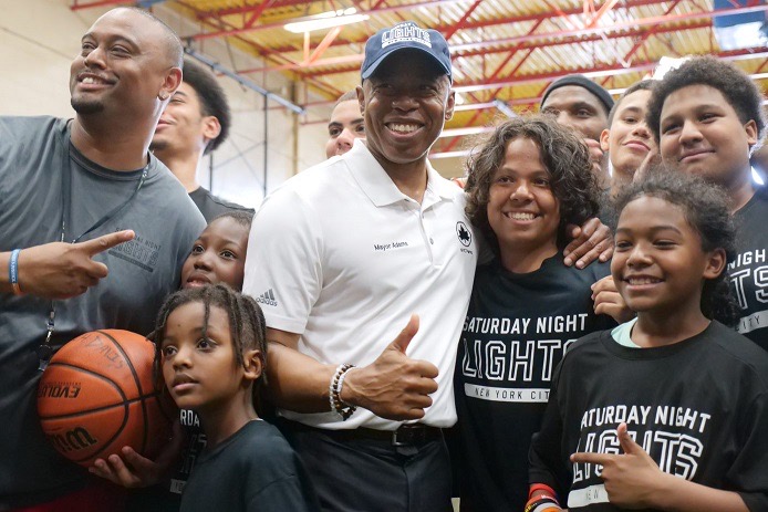 Mayor Adams poses with youth and coaches.